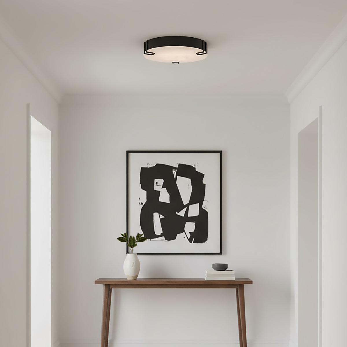 Inez LED Flush Mount 16", Matte Black and Alabaster - A flush mount ceiling light in a white entryway.