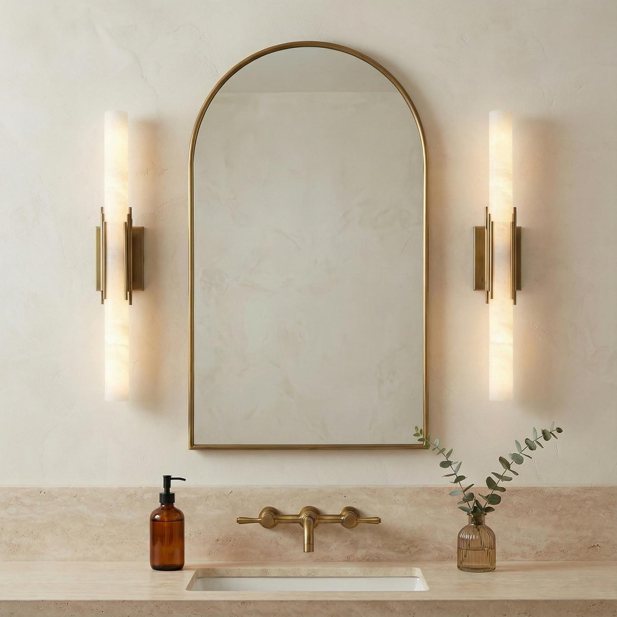 Delya LED Wall Sconce 22, Antique Brass and Alabaster, styled in a Contemporary Bathroom with travertine surfaces.
