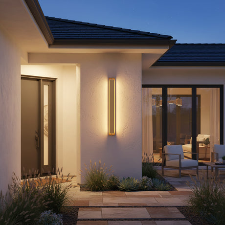 Rye LED Outdoor Wall Light 46", Textured Gold - A modern 46" tall outdoor wall light illuminates an entryway with stone pavers and decorative plants.