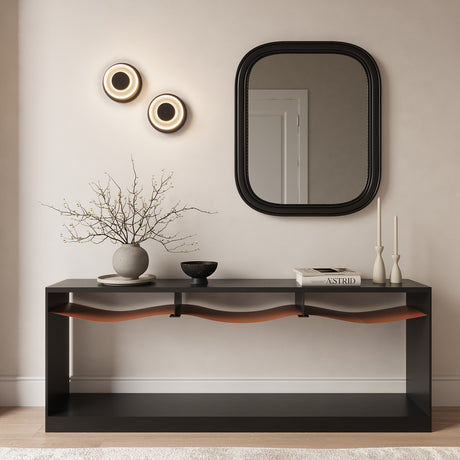 Two Cam LED Wall Sconces in Black and Frosted Glass shown in an entryway above a modern console table with accessories.