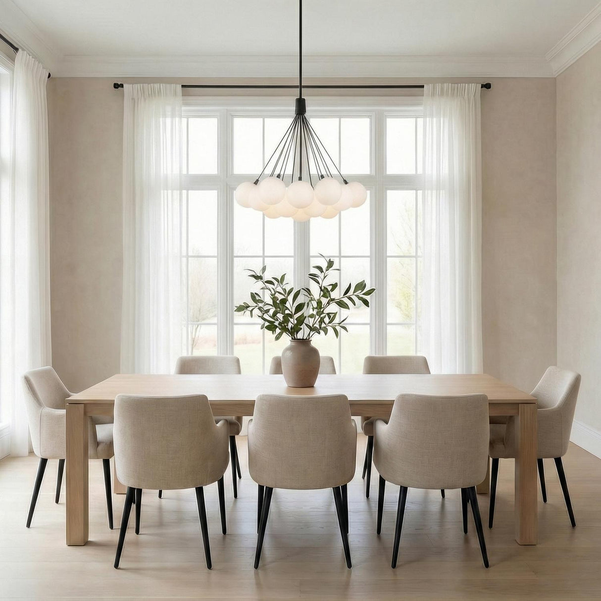 Soren 19 Light LED Chandelier 28", Matte Black and Opal Glass globe chandelier in a Transitional Dining Room with a light oak table.
