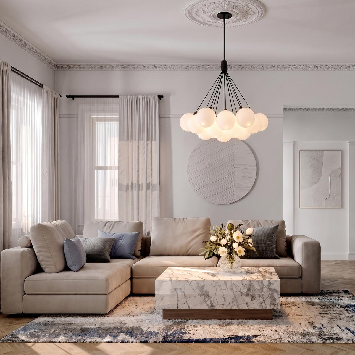 A transitional living room featuring the Soren 19 Light LED Chandelier 28", Matte Black and Opal Glass centered over a marble coffee table and beige sectional sofa.