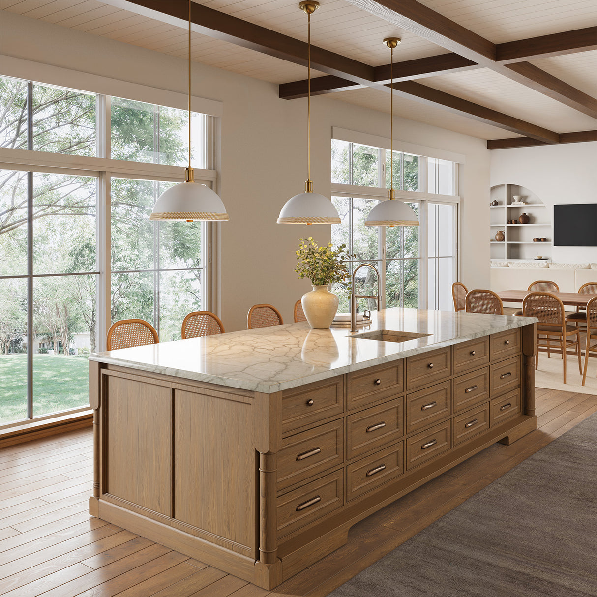 Modern kitchen with a large island and three Alverna 16" pendant lights, Matte White with Rattan Accents.