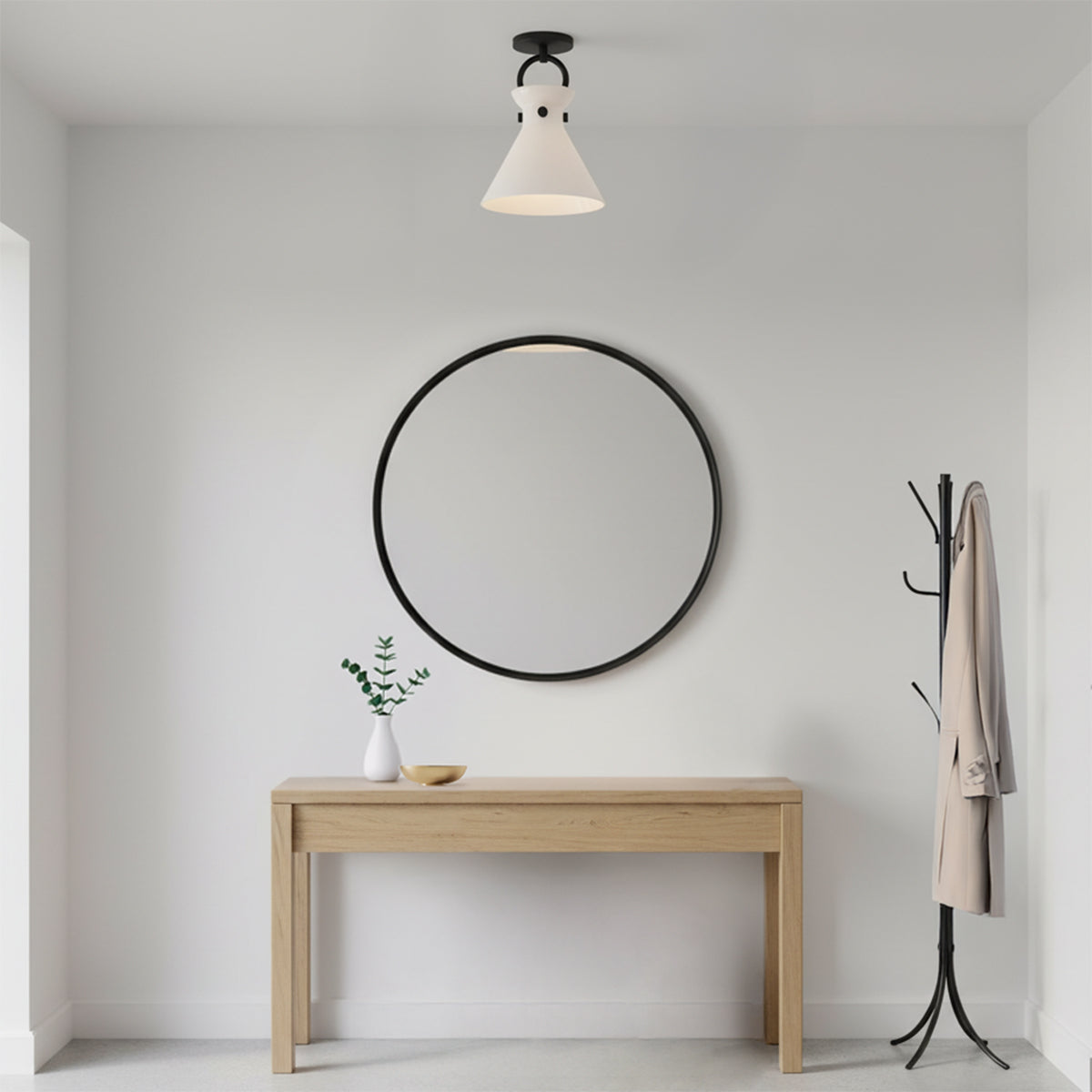 Aris Semi-Flush 9, Matte Black and Milk Glass - A flush mount light fixture hangs above a narrow wooden console table with a round black mirror and a coat rack.
