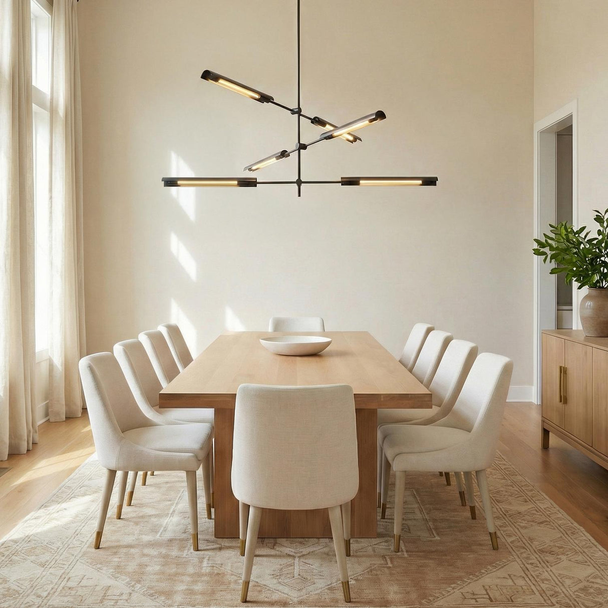 Linden 6 Light LED Chandelier 42", Urban Bronze linear chandelier in a Contemporary Dining Room with a light oak table and cream chairs.