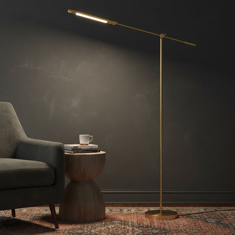 Linden LED Floor Lamp 55, Aged Brass - Floor lamp illuminates a reading nook with a book and coffee