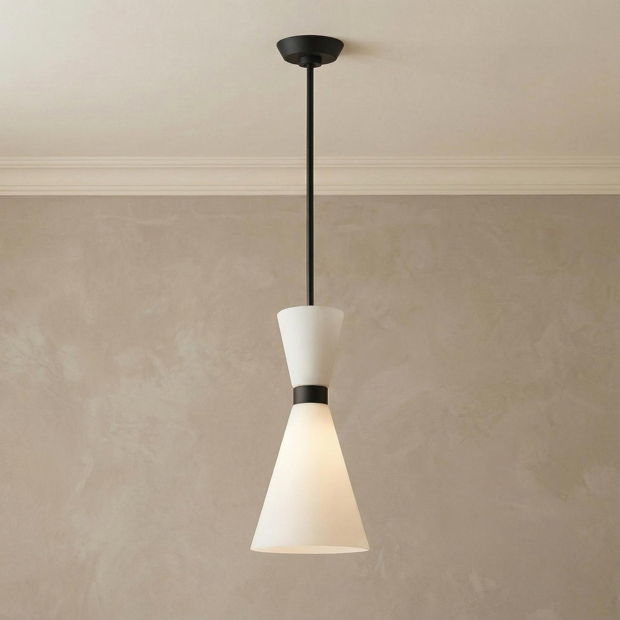 Issa Pendant 8", Matte Black geometric hourglass pendant in a Modern Entryway with textured plaster walls.