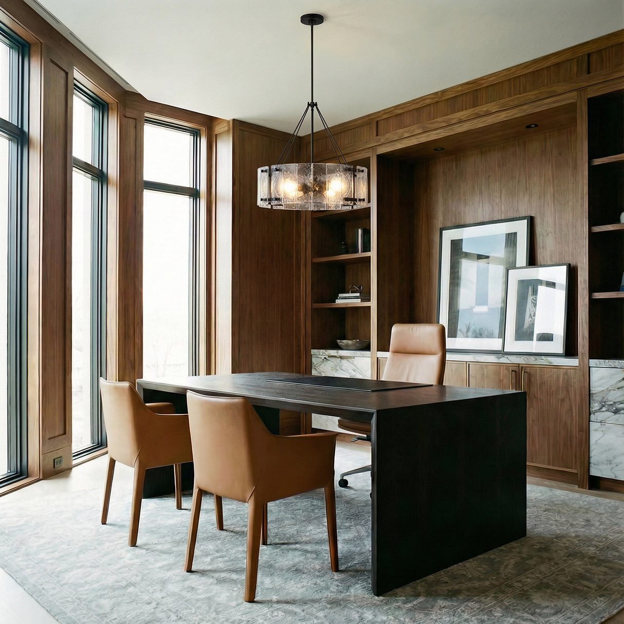 Rift Pendant 20", Matte Black drum-shaped glass and metal pendant in a Modern Office with dark wood paneling and a modern desk.