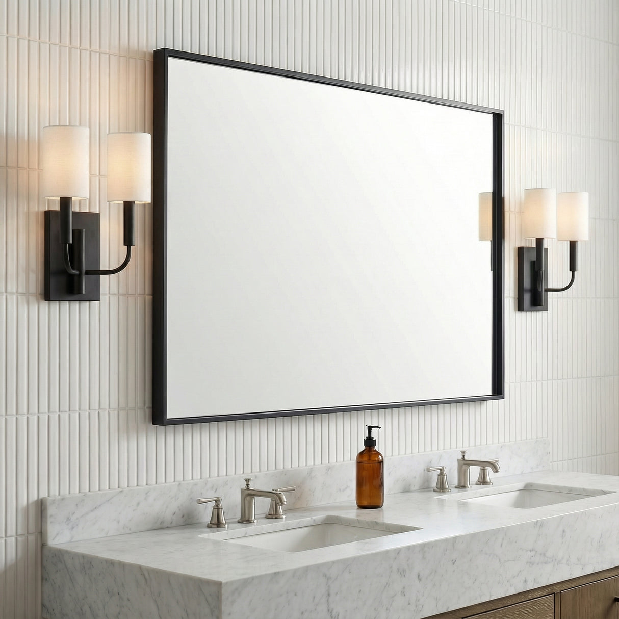 Matte Black linear Wall Sconce in a Transitional Bathroom with a white marble double vanity and ribbed wall tiles.