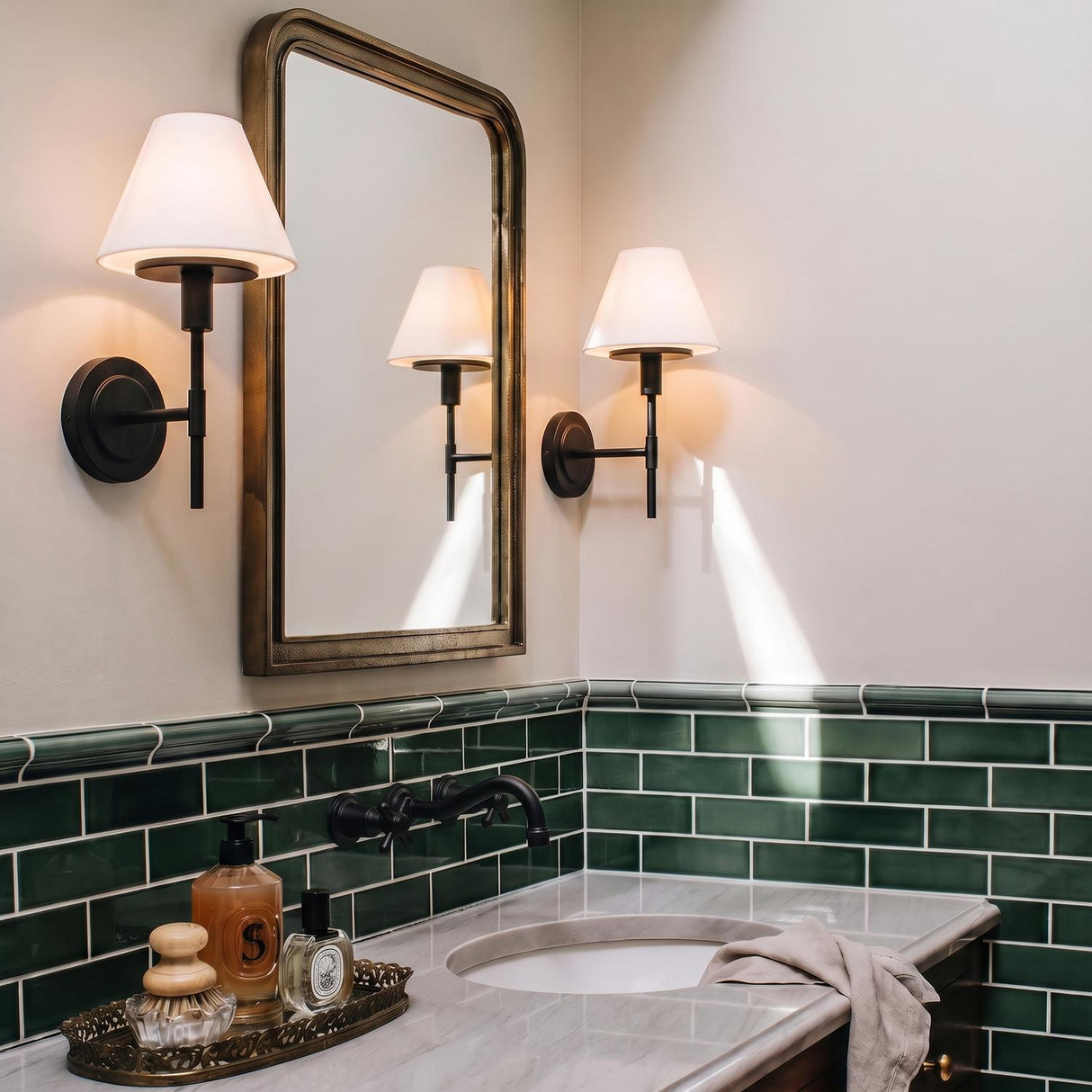 A transitional bathroom featuring the Dean Wall Sconce 14", Matte Black and Opal Glass flanking a rectangular mirror above green subway tile and a marble vanity.