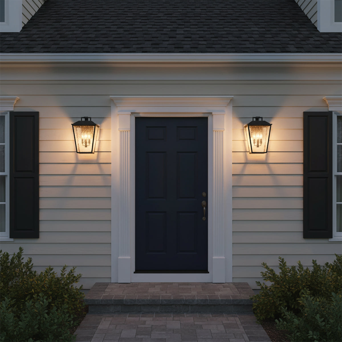 Harrison Outdoor Large Wall Light 16, Textured Black - Two outdoor lanterns flanking a dark blue door with white trim, illuminated at dusk.