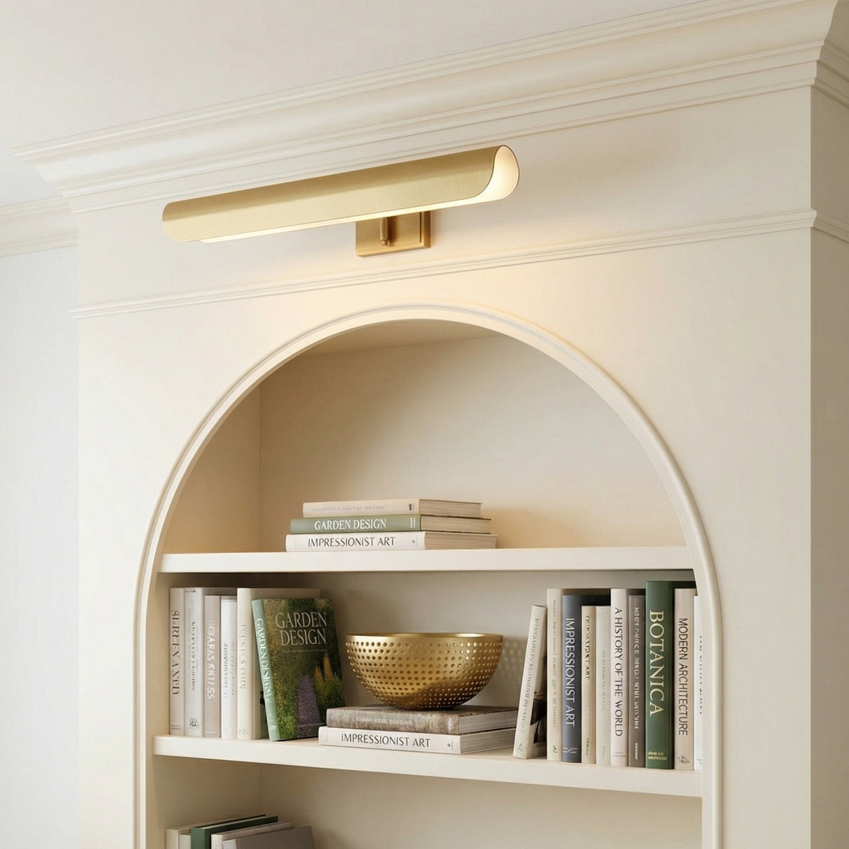 Denton Picture Light 24, Modern Brass, styled in a Traditional Living Room with built-in shelving.