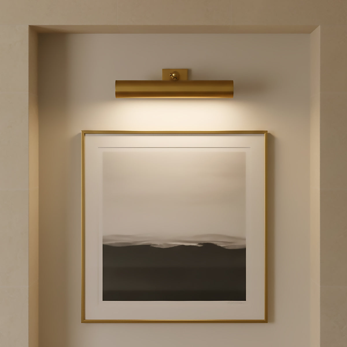Framed artwork on a wall with the Gunther Picture Light 18", in Modern Brass above.