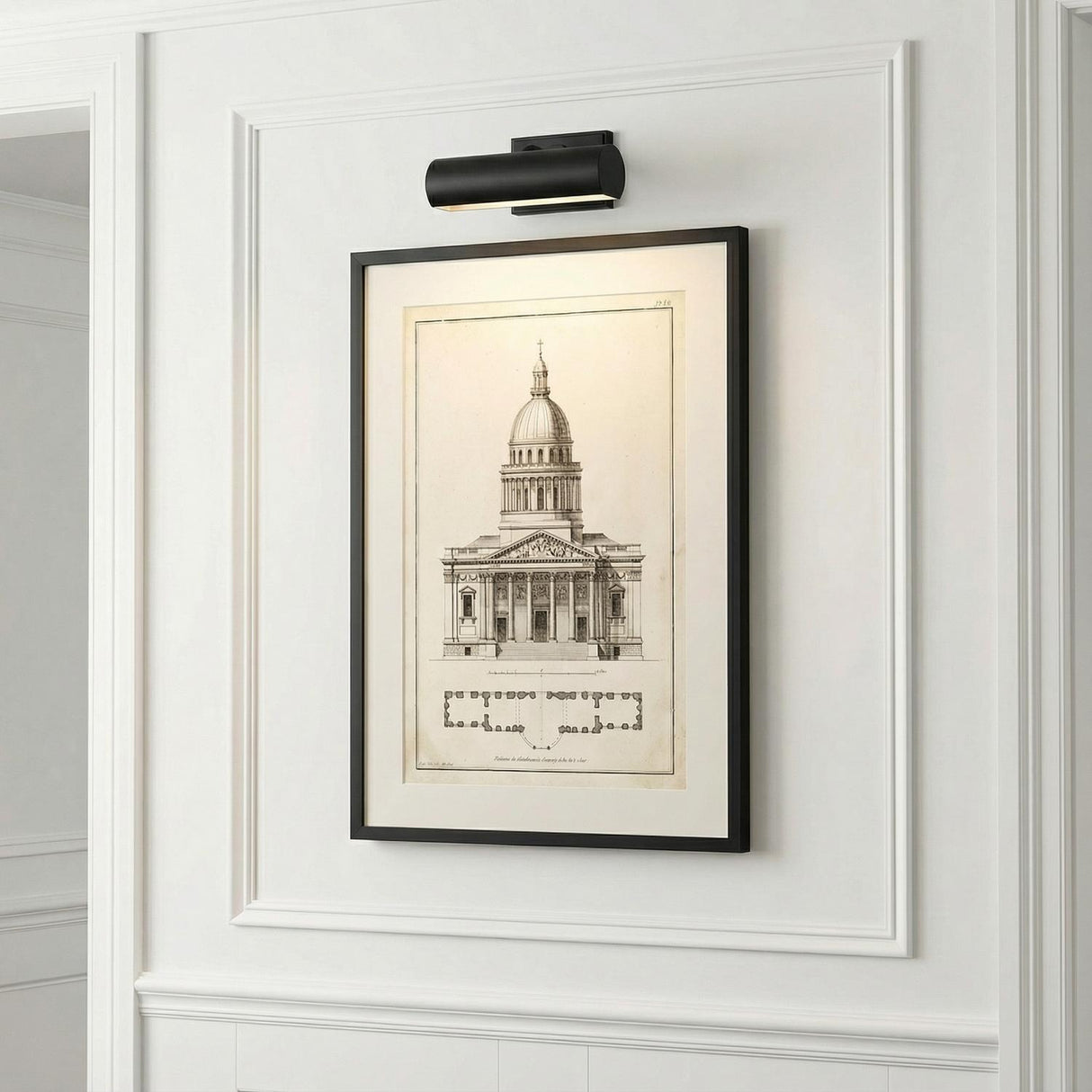 Gunther Picture Light 10", Matte Black linear picture light in a Transitional Entryway with architectural artwork and wainscoting.