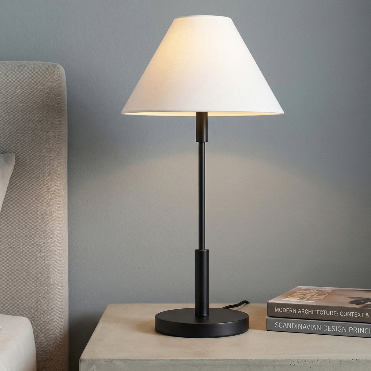 Hazelton Table Lamp, Matte Black linear Table Lamp in a Modern Bedroom with a concrete nightstand.