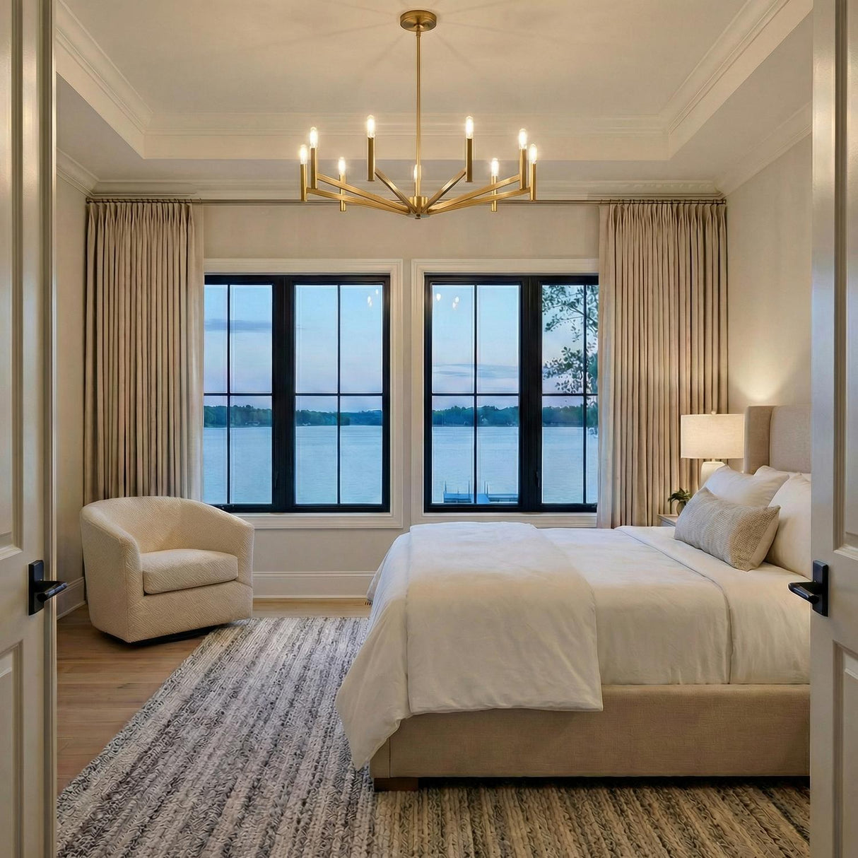 Foster 9 Light Chandelier 36", Satin Brass geometric chandelier in a Transitional Bedroom with a beige upholstered bed and lake view.