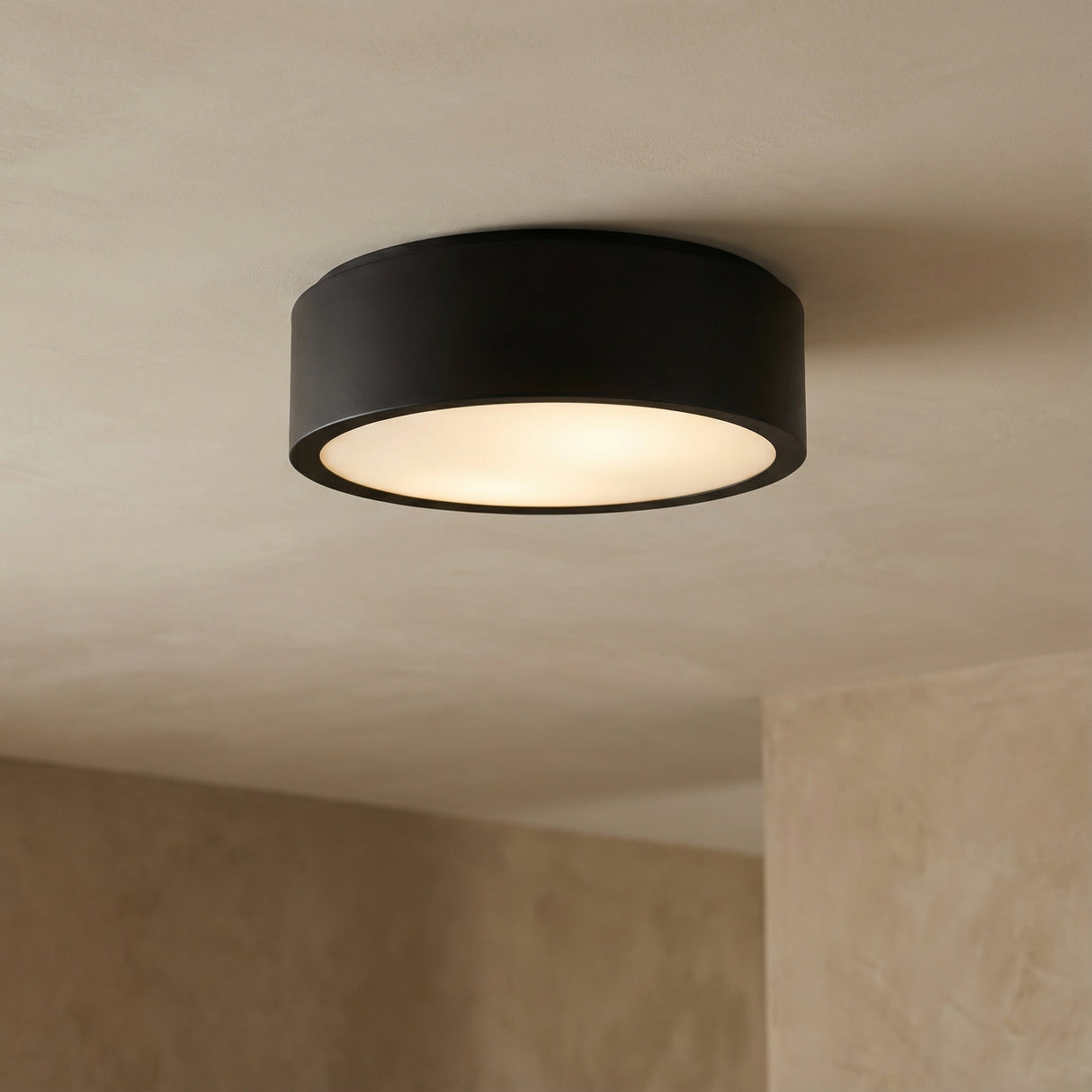 Matte Black geometric flush mount in a Modern Living Room with a minimalist textured wall.