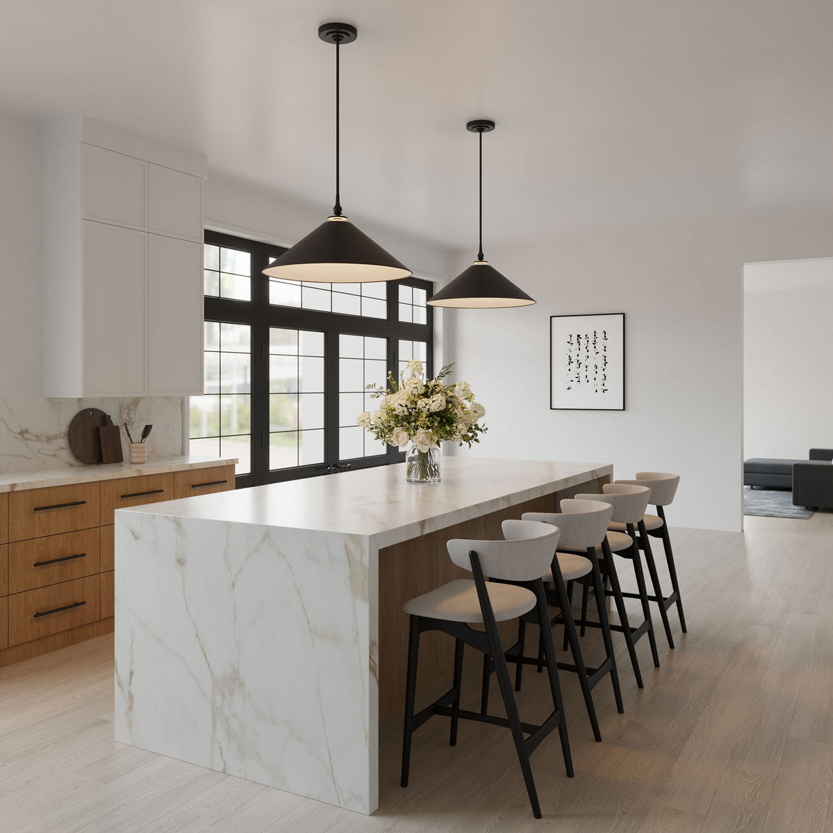 Two 24" wide Emerson pendant lights hung in a modern white kitchen above a large island with waterfall edges and seating for four.