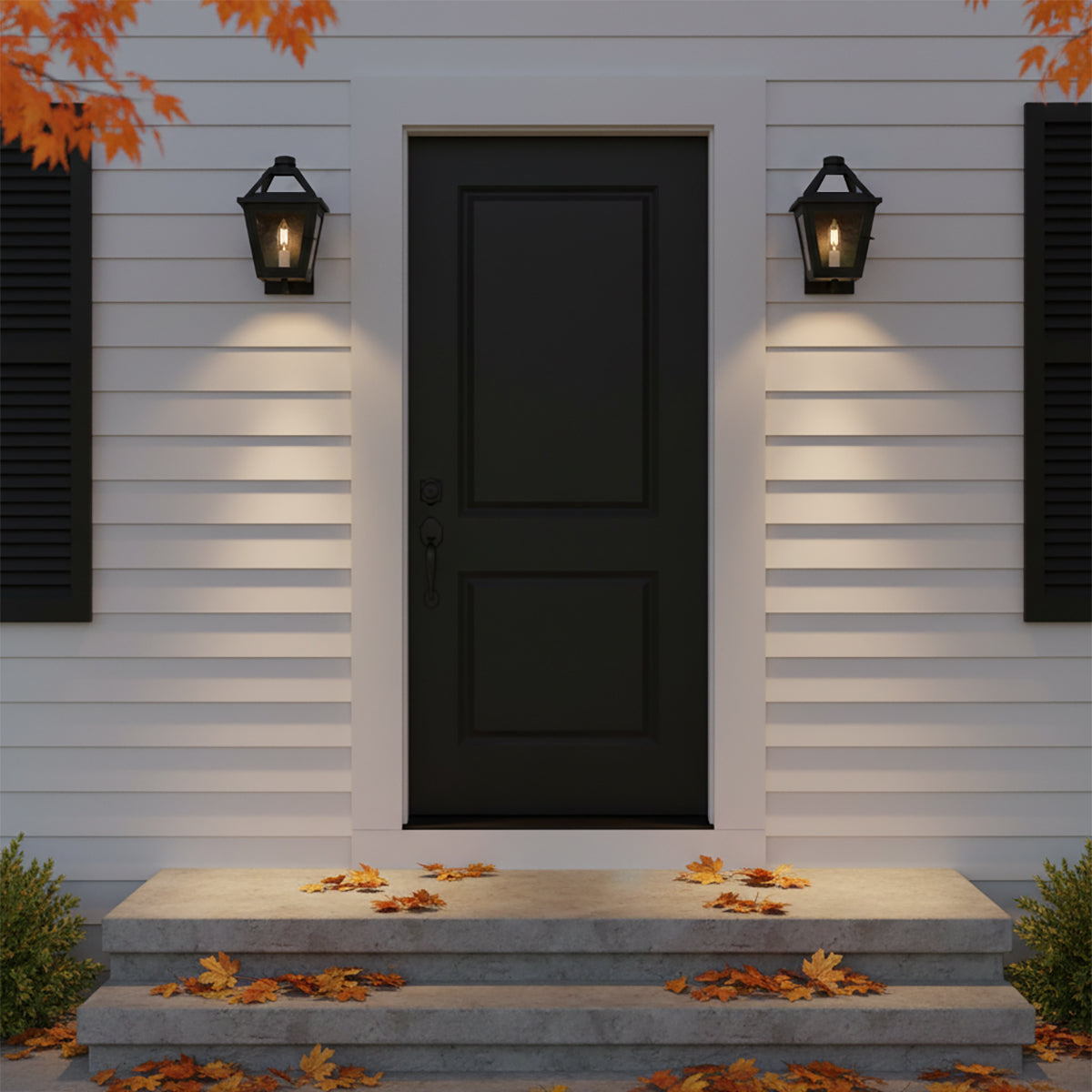 Fairmont Extra Small Outdoor Wall Light 13 - Two black lanterns flank a black front door with white siding and fallen autumn leaves on the steps.