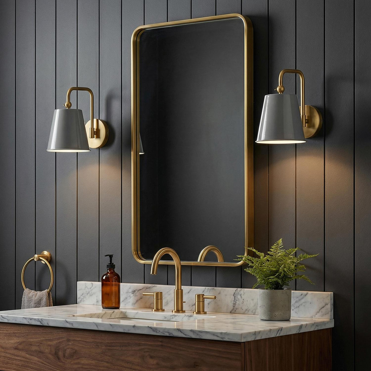 Weston Gray and Satin Brass geometric Wall Sconce in a Modern Farmhouse Bathroom with a marble vanity and gold mirror.