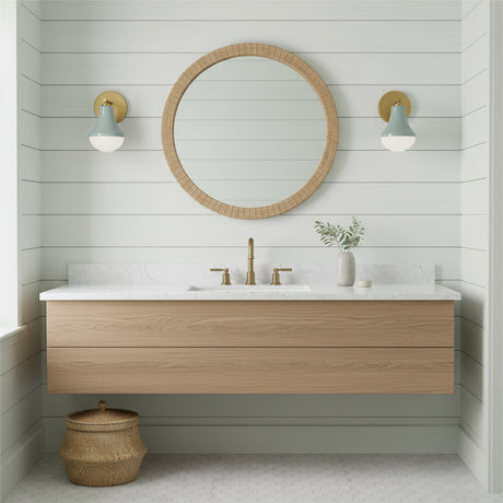 Skylar Wall Sconce 9", Aquaverde and Satin Brass - A bathroom with wall sconces flanking a round mirror.
