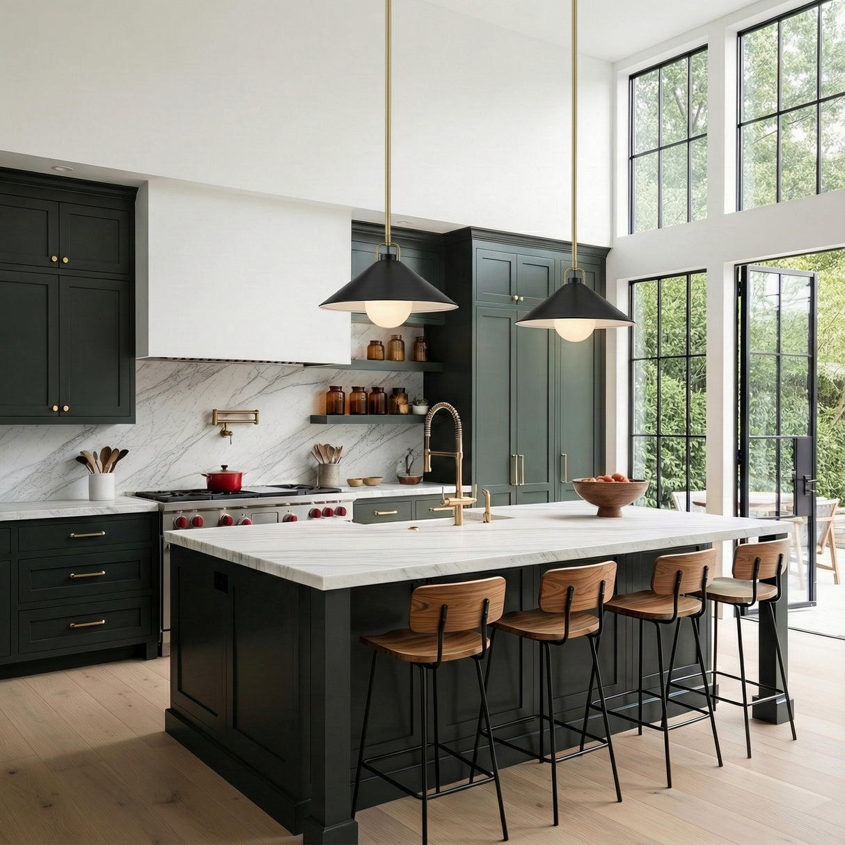 Nyra Pendant 16, Satin Brass and Black styled in a Modern Kitchen with marble island and dark green cabinetry.