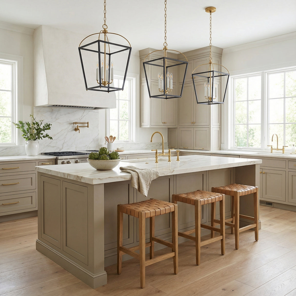Langford Large Lantern Pendant 16", Black and Satin Brass geometric Pendant in a Transitional Kitchen with a white marble island and woven leather stools.