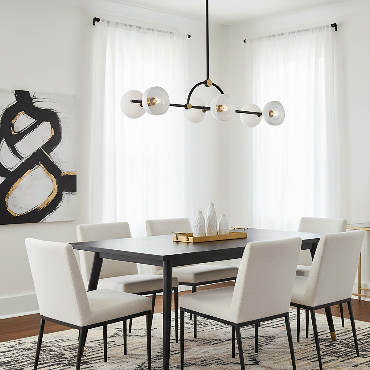 Penrose 6 Light Linear Pendant 43, Aged Brass and Textured Black - Dining room with a six-light linear pendant above a black dining table