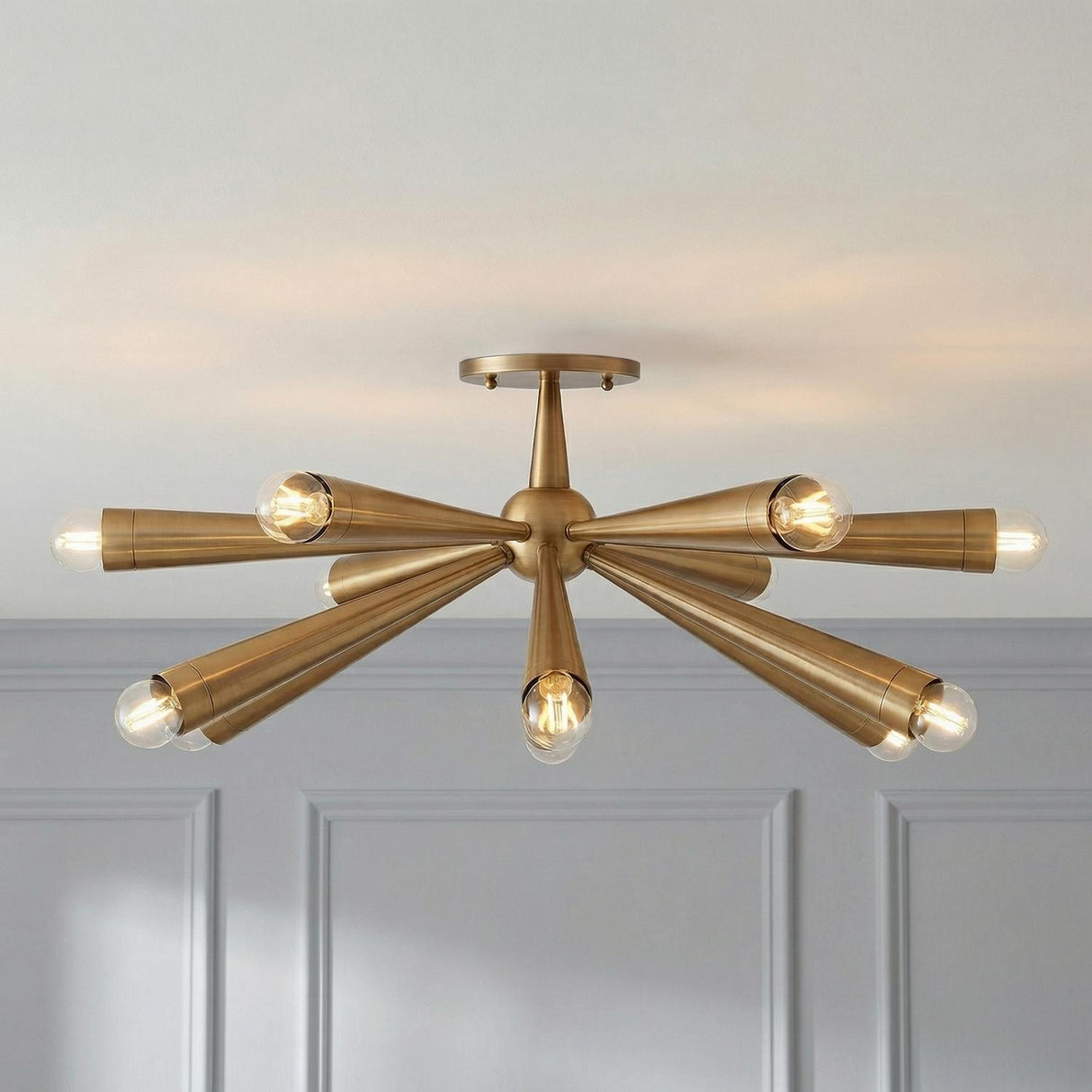 Camellia Semi Flush 30", Patina Brass linear design Flush Mount in a Transitional Living Room with grey paneled walls.