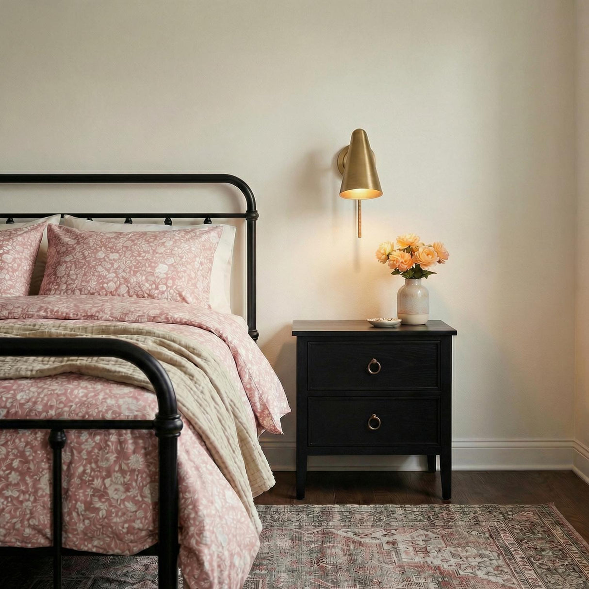 Atlas Wall Sconce 11", Patina Brass geometric wall sconce in a Modern Farmhouse Bedroom with a black iron bed and floral bedding.