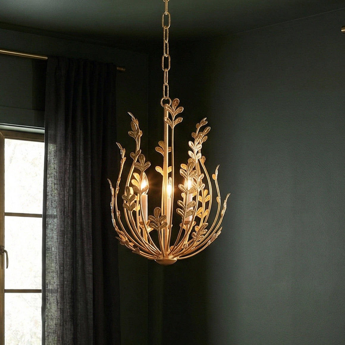 Annelise Chandelier 14", Gold leaf design Chandelier in a Transitional Living Room with deep green walls and dark grey curtains.