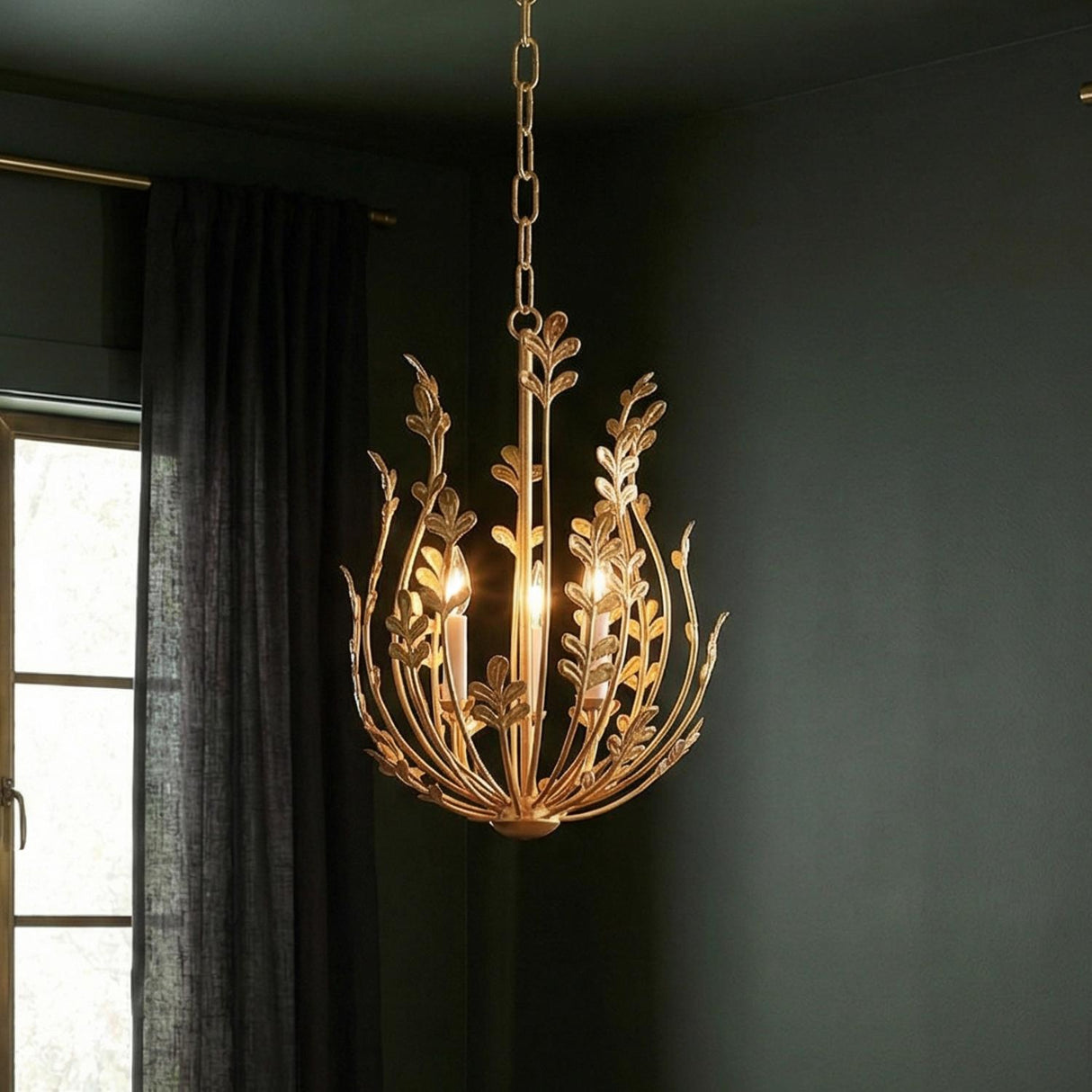 Annelise Chandelier 14", Gold leaf design Chandelier in a Transitional Living Room with deep green walls and dark grey curtains.