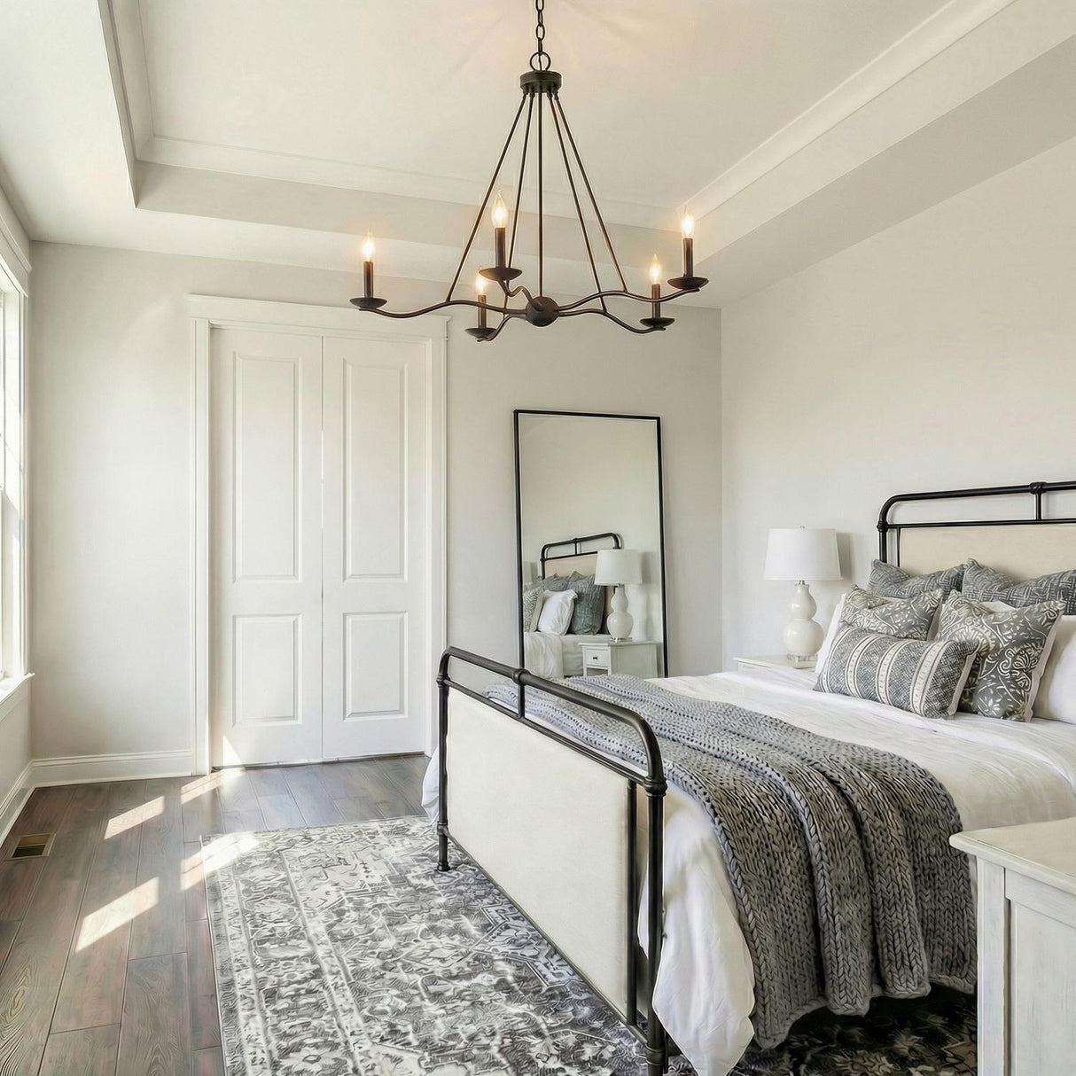 Tamsin 6 Light Chandelier 40, Forged Iron geometric Chandelier in a Modern Farmhouse Bedroom with an iron bed and patterned rug.