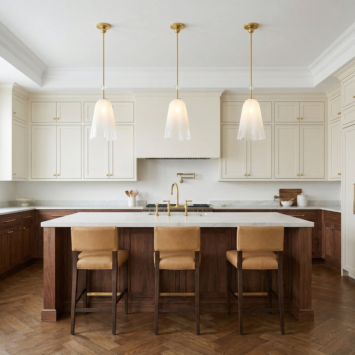 Cora Pendant, Brass linear pendant in a Transitional Kitchen with a white marble island and tan leather stools.