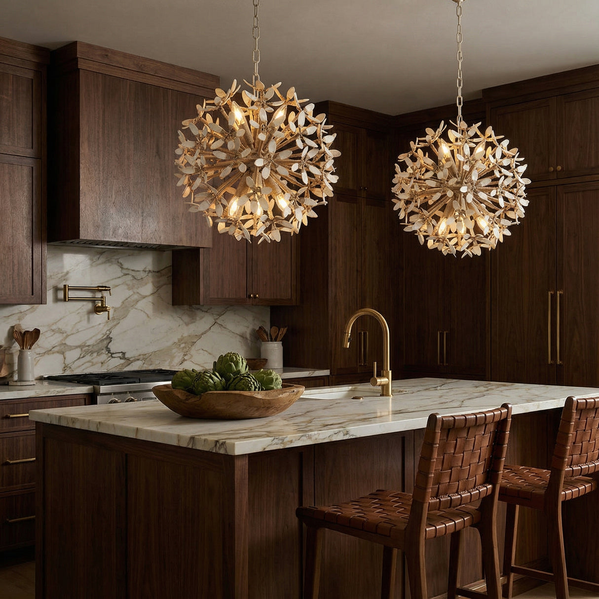 Distressed gold off-white leaf design Chandelier in a Transitional Kitchen with a marble island & woven leather stools.