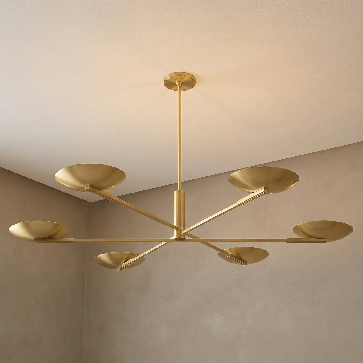 Phoebe 6 Light LED Chandelier 56", Aged Brass geometric Chandelier in a Modern Living Room with neutral textured walls.