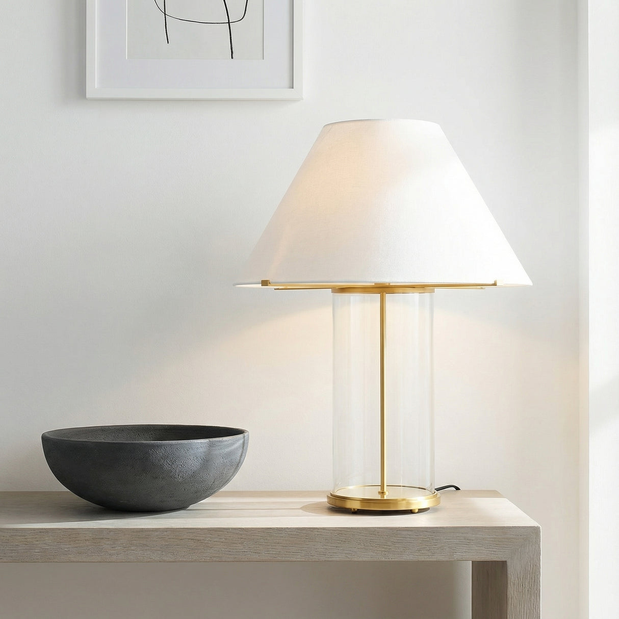Elena Table Lamp, Brass and Clear Glass geometric Table Lamp in a Modern Living Room with a light wood console table and dark bowl.