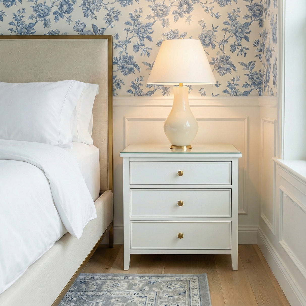Lucille Table Lamp, Glossy Cream globe Table Lamp in a Traditional Bedroom with blue floral wallpaper.
