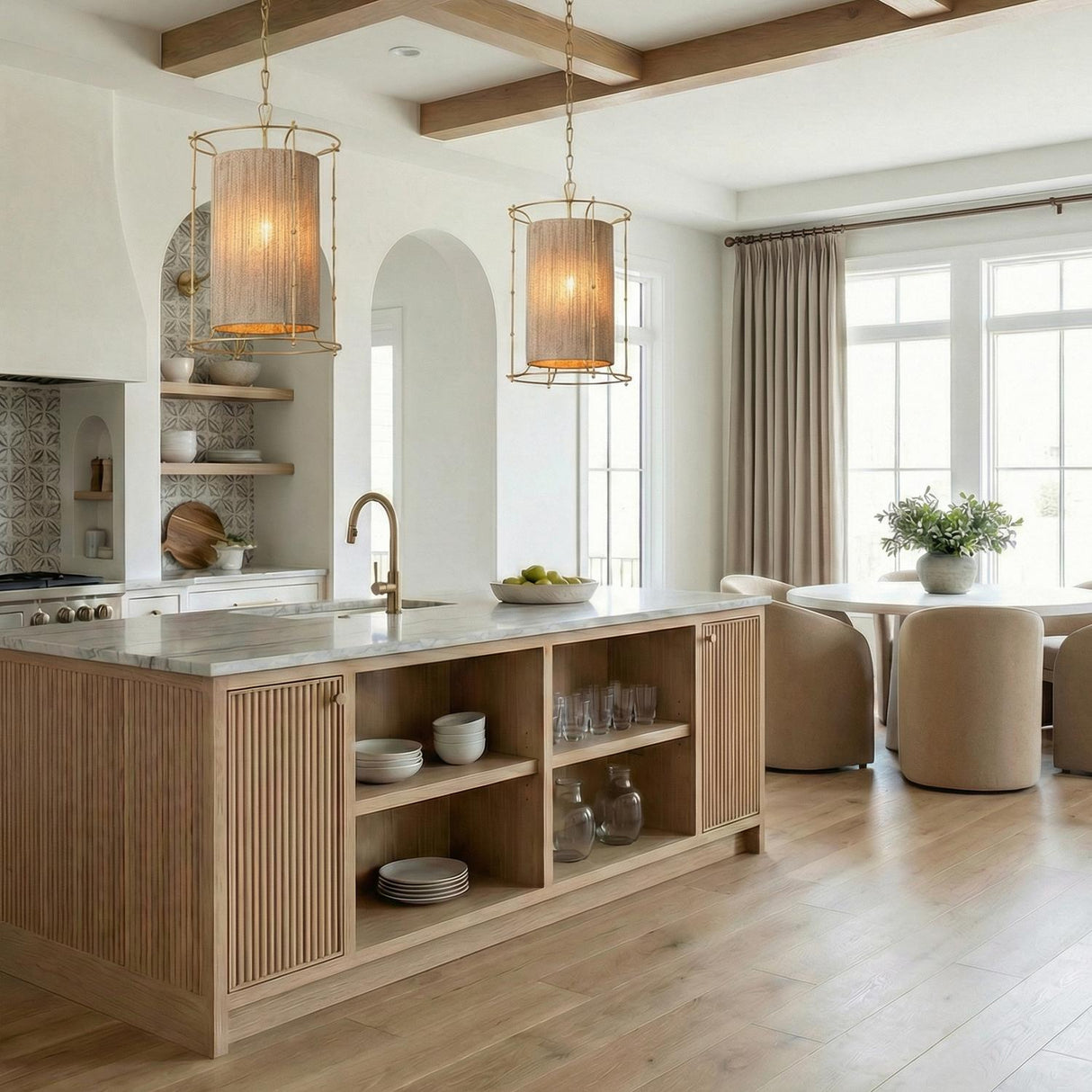 Gold and woven cylinder pendant in a Transitional Kitchen with a white marble island and arched alcoves.
