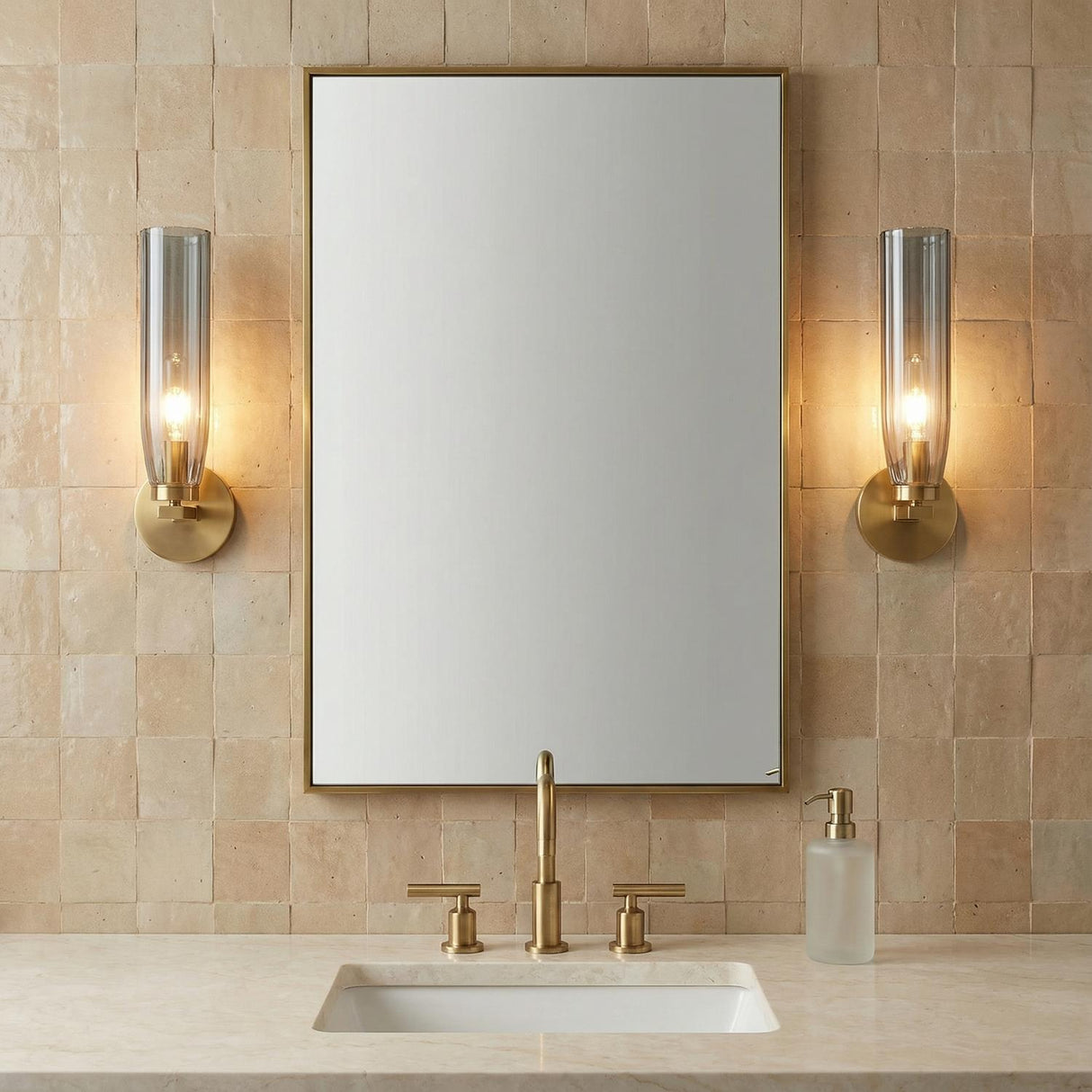 Ernest Wall Sconce 14", Aged Brass and Smoke Glass linear Wall Sconce in a Contemporary Bathroom with beige zellige tile and brass mirror.