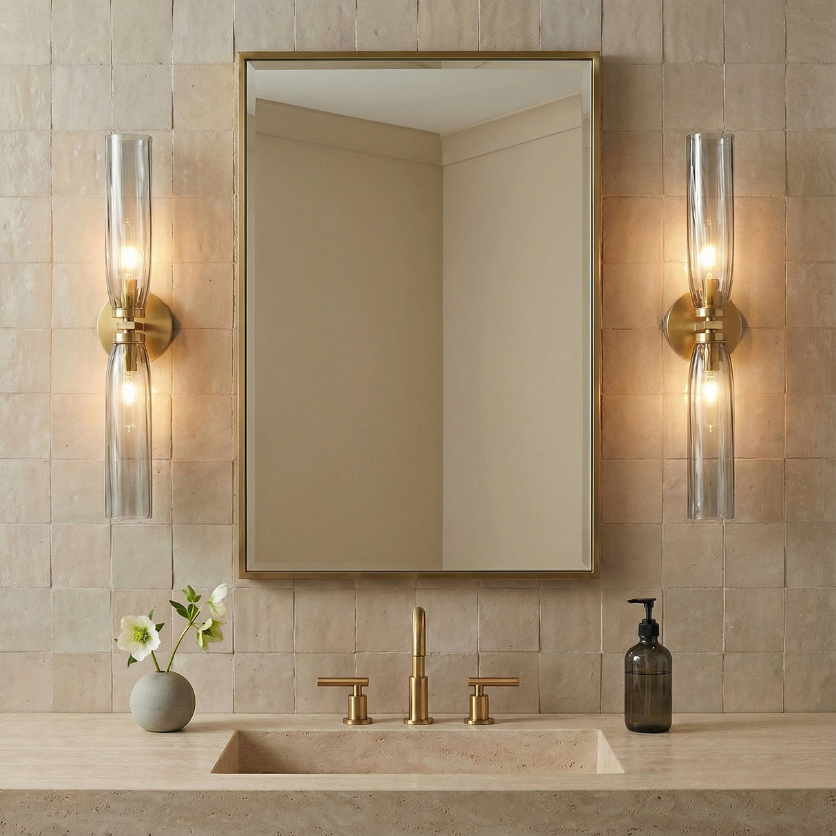 Ernest 2 Light Wall Sconce 24", Aged Brass and Smoke Glass linear Wall Sconce in a Contemporary Bathroom with neutral tile and a stone vanity.