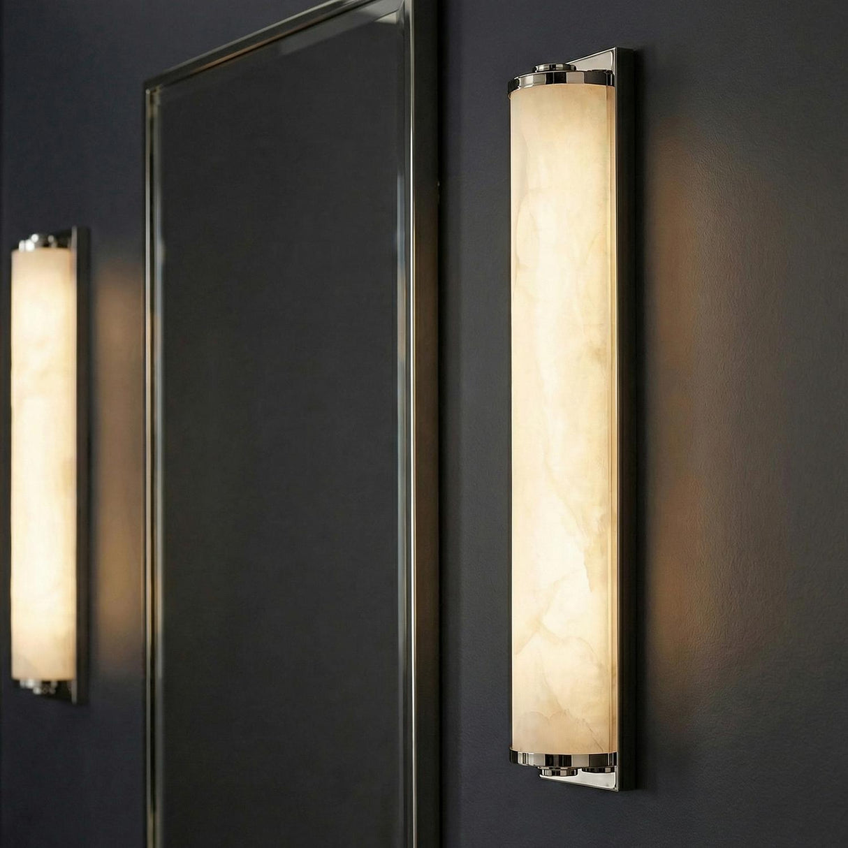 Abigail LED Wall Sconce 25", Polished Nickel linear Wall Sconce in a Contemporary Bathroom with a silver framed mirror.