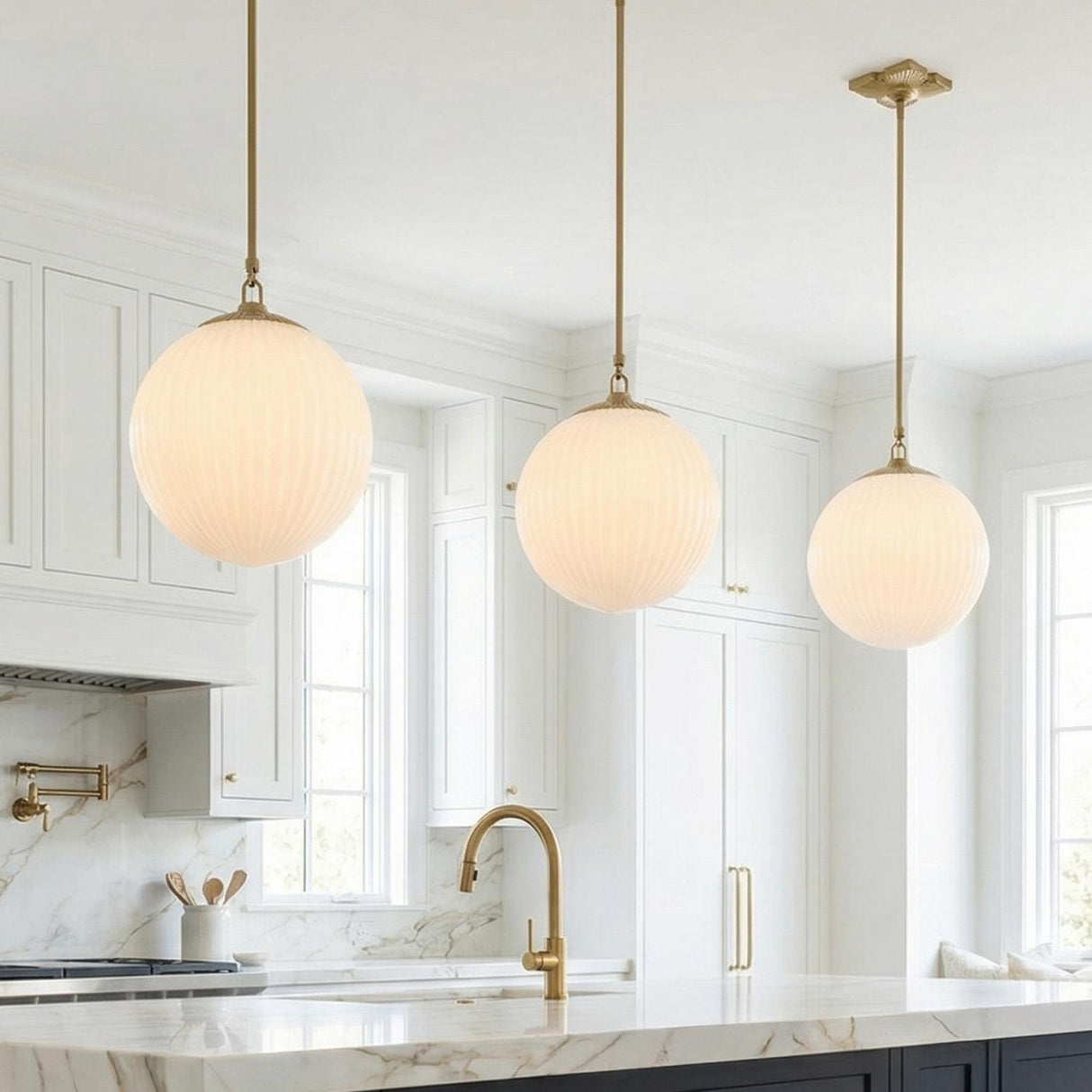 Victoria Pendant, Aged Brass and Opal Ribbed Glass globe pendant in a Transitional Kitchen with a white marble island.