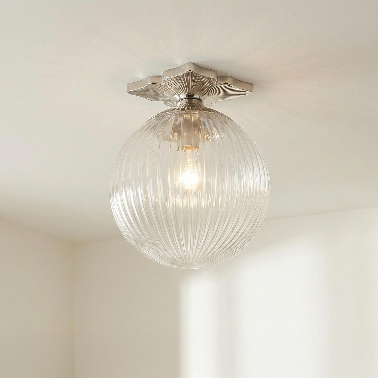 Victoria Semi-Flush 10", Polished Nickel scalloped globe Flush Mount in a Transitional Hallway with minimalist white walls.
