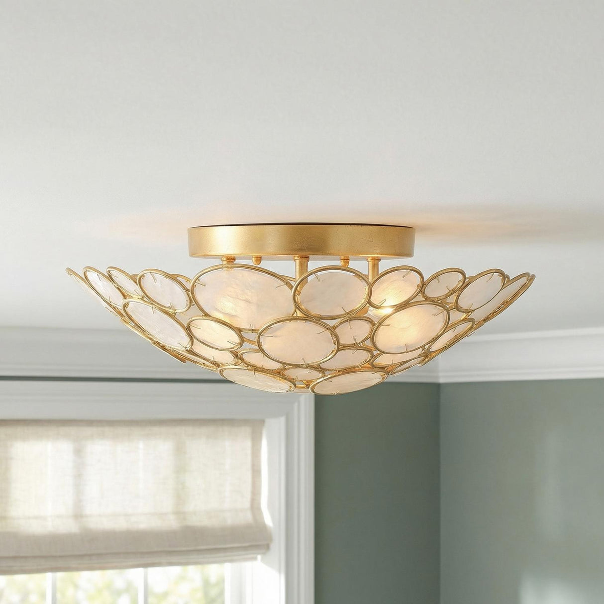 Aurelie Semi-Flush 16", Antique Gold with Capiz Shell scalloped Semi-Flush in a Coastal Bedroom with sage green walls and a Roman shade.