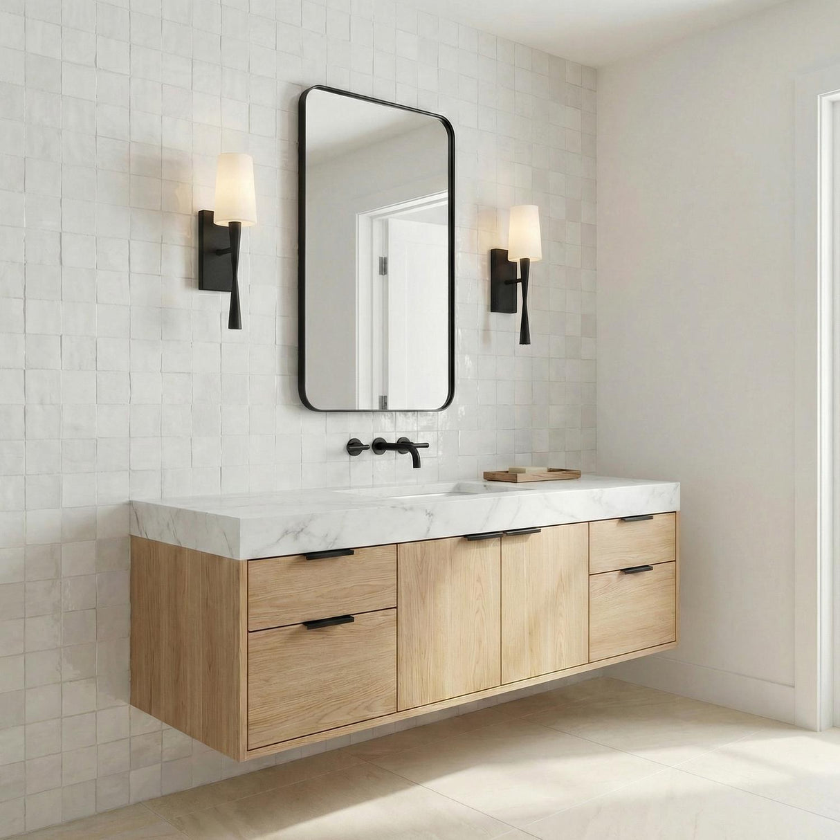 Kellan Wall Sconce 18", Black linear Wall Sconce in a Modern Bathroom with a floating light oak vanity and marble counter.
