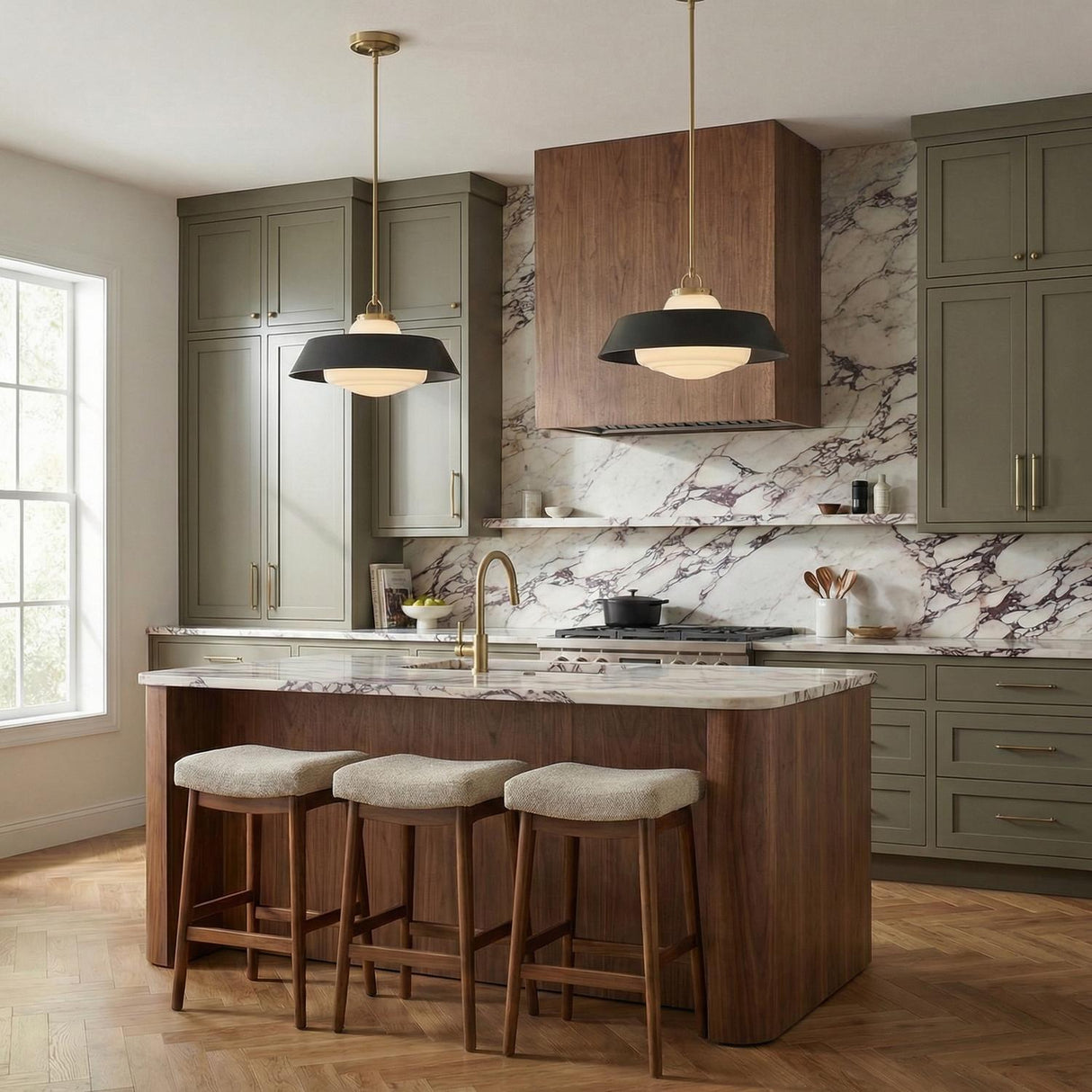 A modern kitchen features two Blaine Large Pendant 20", Brass and Matte Black fixtures over a walnut island with purple veined marble and olive green cabinets.