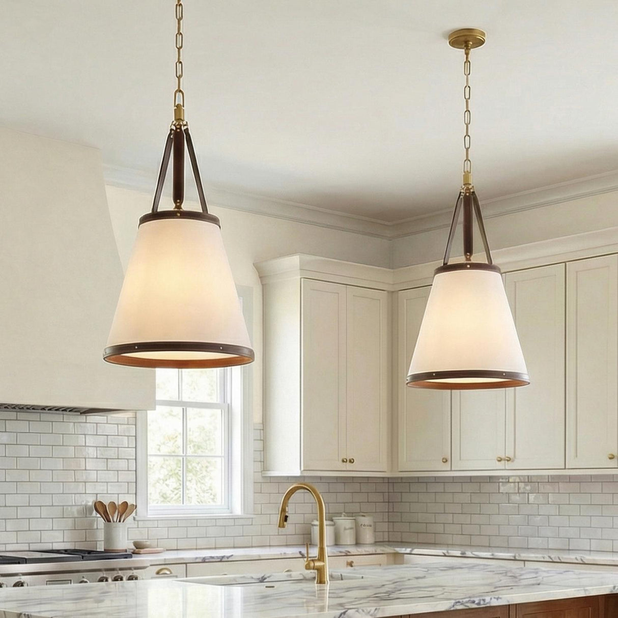 Spencer Brass with Brown Leather Accents geometric pendant in a Modern Farmhouse Kitchen with a white marble island.