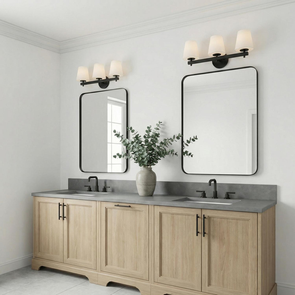 Atticus 3 Light Vanity, Black and Opal Glass linear Vanity in a Transitional Bathroom with a double vanity and eucalyptus.