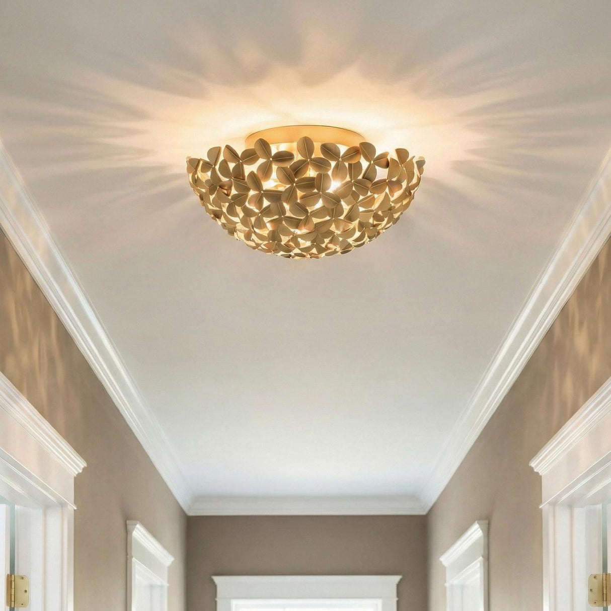 Florence Flush Mount, Soft Brass leaf design flush mount in a Transitional Hallway with white crown molding.